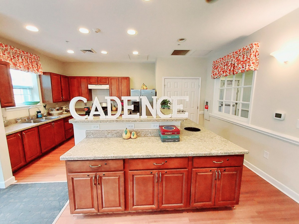 A spacious kitchen with wooden cabinets and a central island.