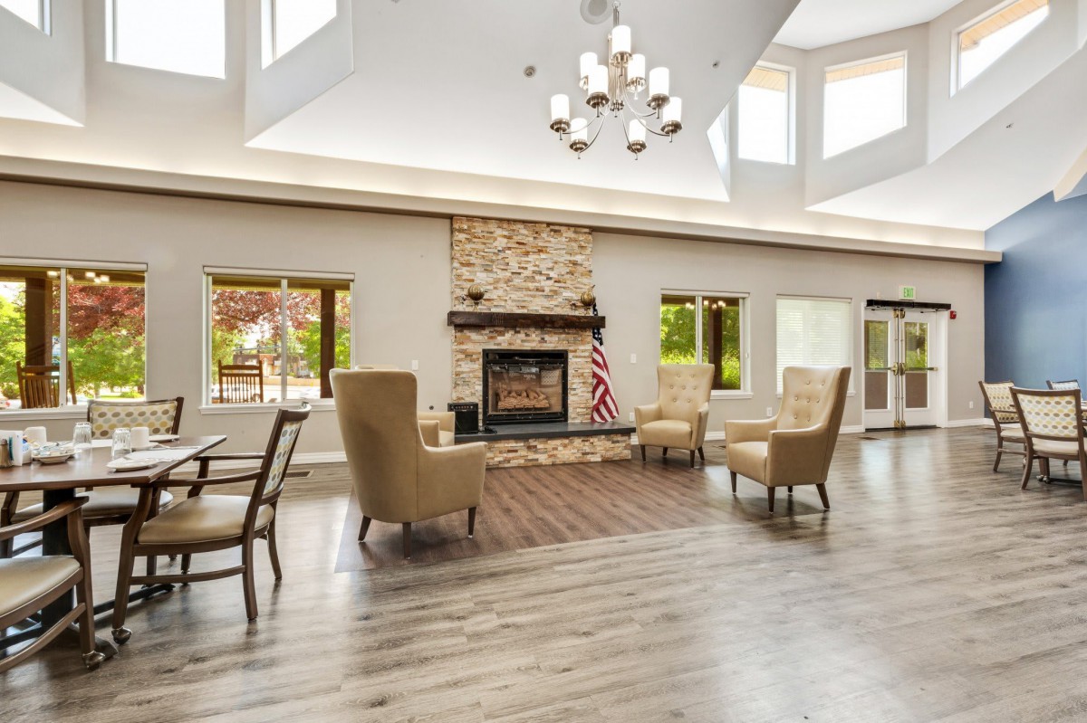 A spacious and bright living room with modern furniture and a stone fireplace.