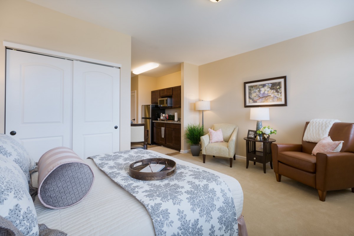 A cozy modern bedroom with stylish decor and comfortable seating.