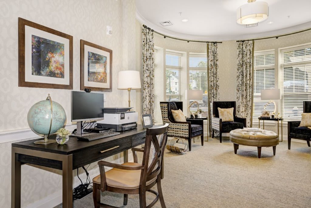 Elegant home office with a cozy seating area and tasteful decor.