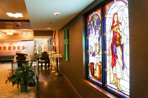 A beautifully decorated hallway featuring vibrant stained glass windows, adding an artistic touch to the interior space.