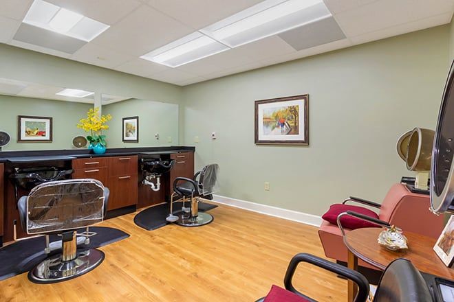 A modern hair salon with styling chairs and a hairstyling station.