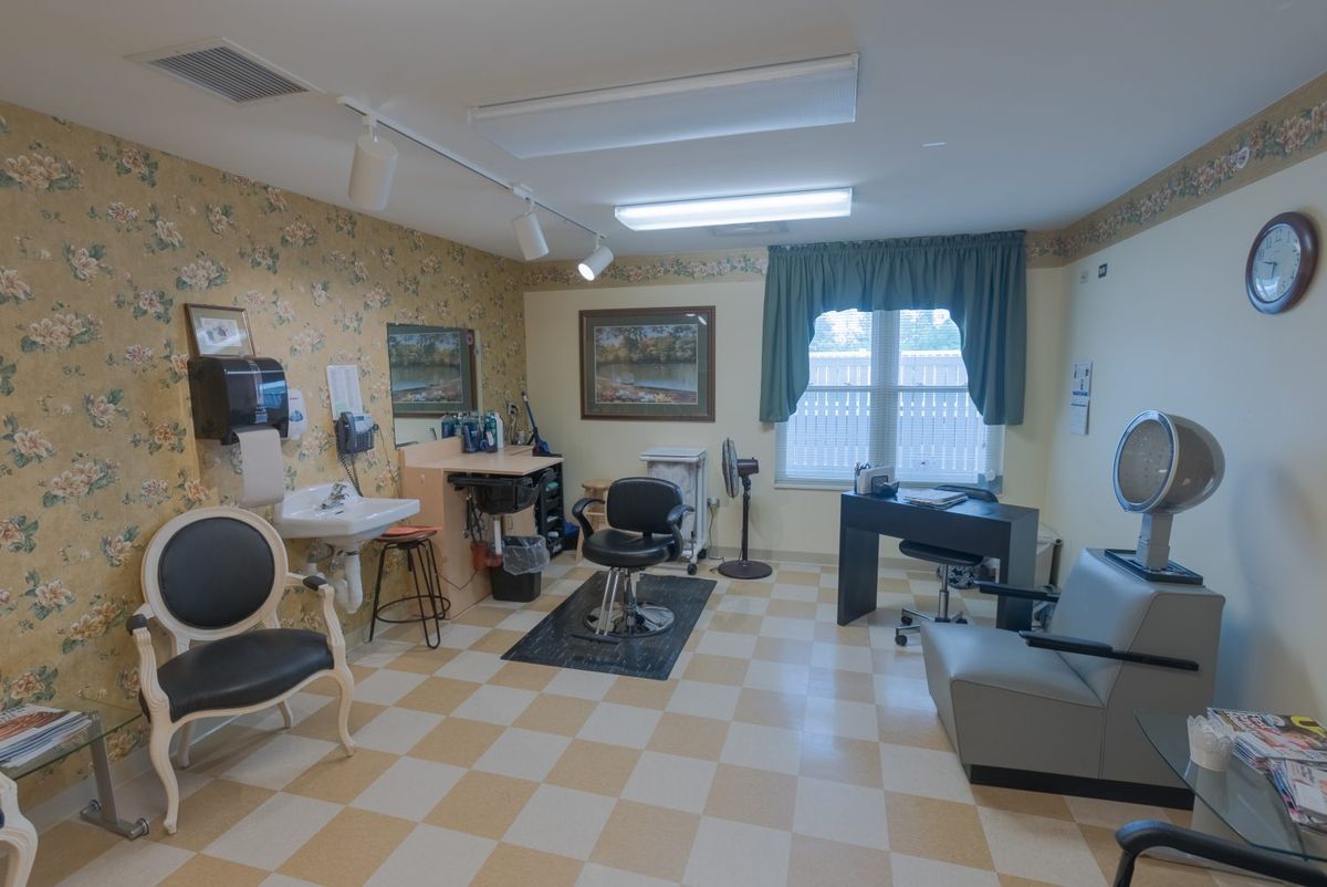A cozy barber shop interior with classic checkered flooring and vintage decor.