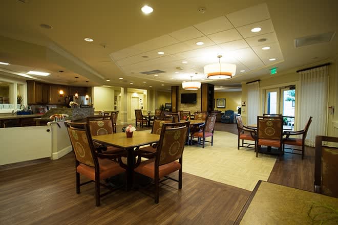 A cozy dining area with elegant lighting and comfortable seating arrangements.