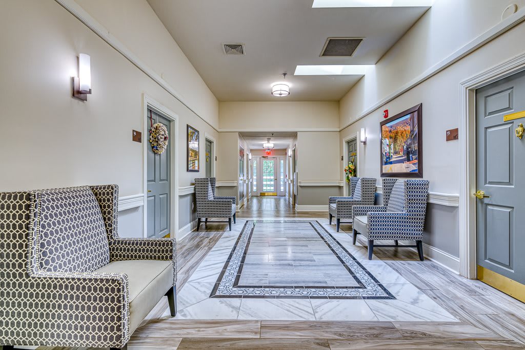 A modern hallway with comfortable seating and elegant decor.
