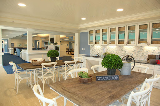 A beautifully designed open-concept kitchen and dining area featuring modern furnishings and greenery.
