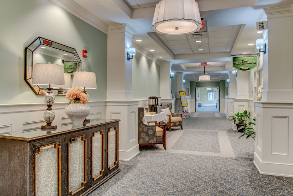 A beautifully decorated hallway with elegant furniture and soft lighting.