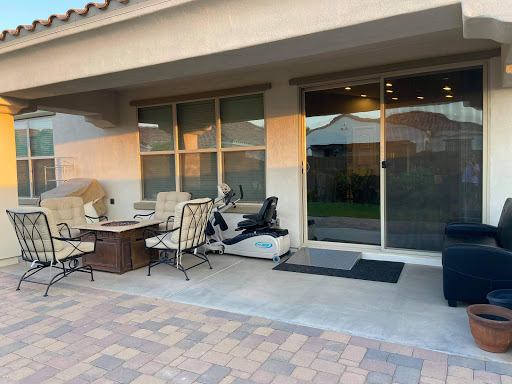 A cozy outdoor patio space featuring comfortable seating, perfect for relaxation in the evening.