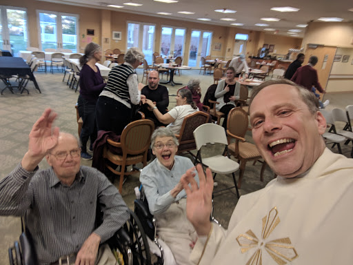 A joyful moment captured at a community celebration, with smiling attendees enjoying each other's company.