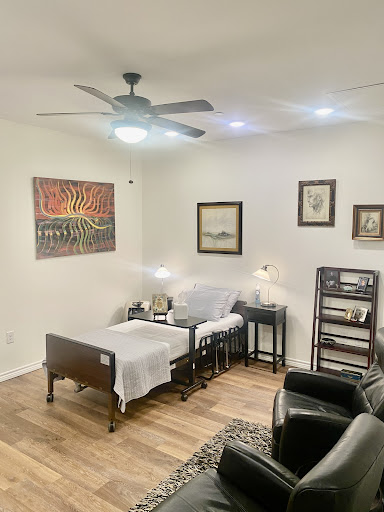 A cozy living area featuring a blend of modern and classic decor, including artwork on the walls and comfortable seating.
