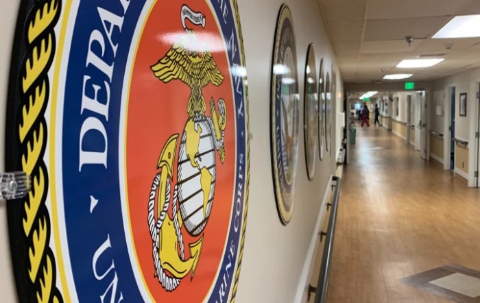 A hallway decorated with military emblems on the walls.