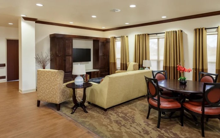 A cozy living room with comfortable seating, a TV, and elegant decor.