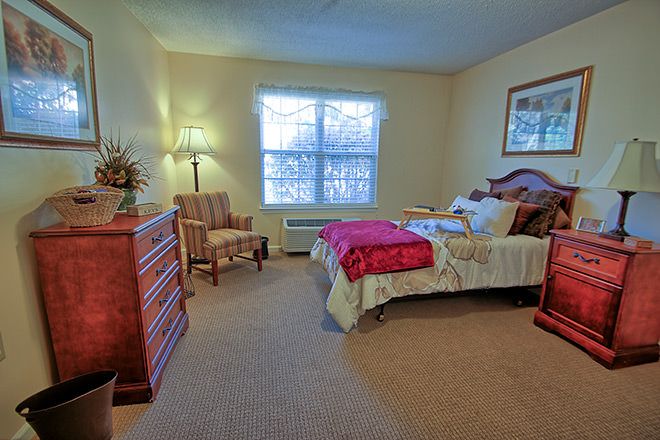 A cozy bedroom with warm lighting and traditional furniture.
