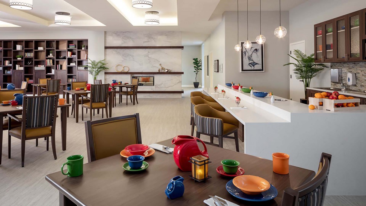 A modern dining room with colorful tableware and elegant lighting.