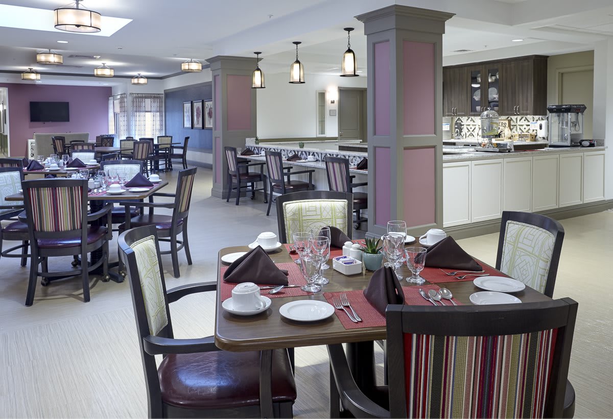 A modern restaurant dining area with neatly arranged tables and chairs.