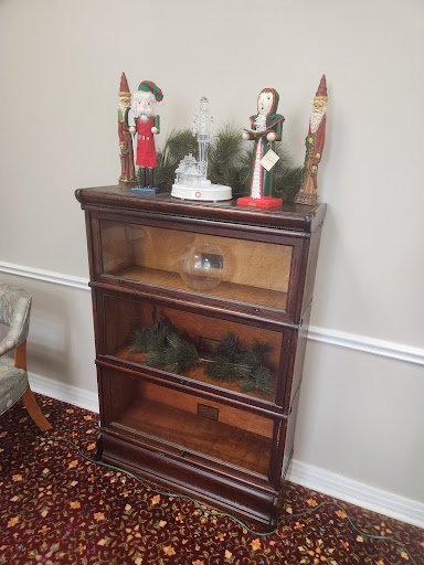 A wooden shelf adorned with holiday decorations and figurines.