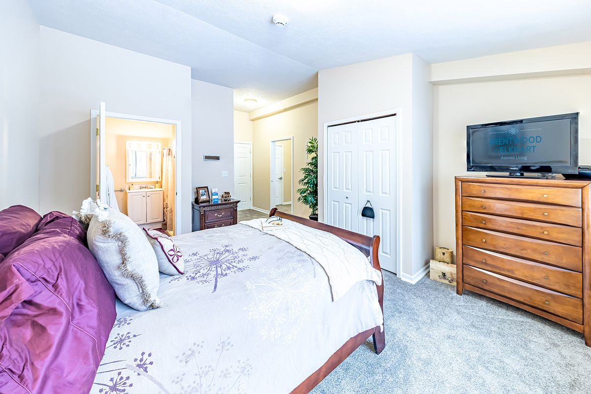 A cozy bedroom with elegant furniture and soft lighting.