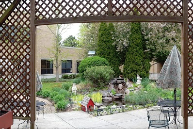 A serene garden featuring a water fountain and lush greenery, perfect for relaxation.