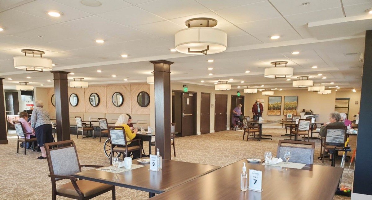 A spacious dining area with tables, chairs, and ambient lighting.