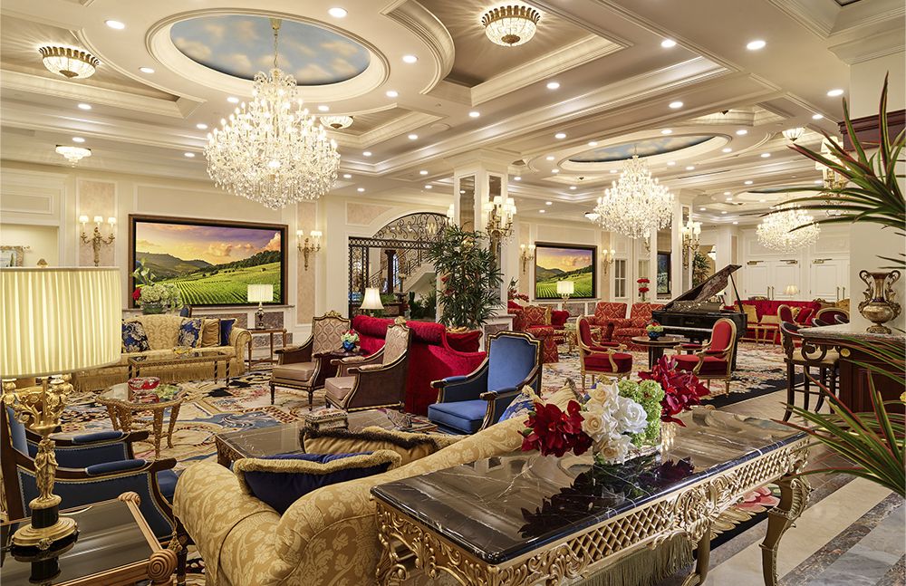 A luxurious hotel lounge with elegant chandeliers and opulent furnishings.