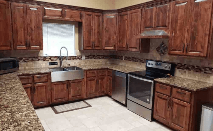 A modern kitchen with wooden cabinets and stainless steel appliances.