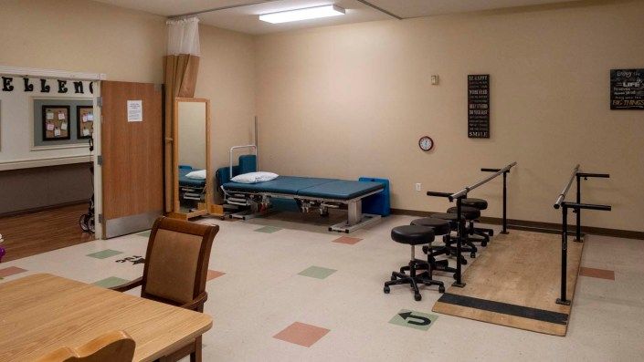 A rehabilitation clinic featuring treatment tables and therapy equipment.