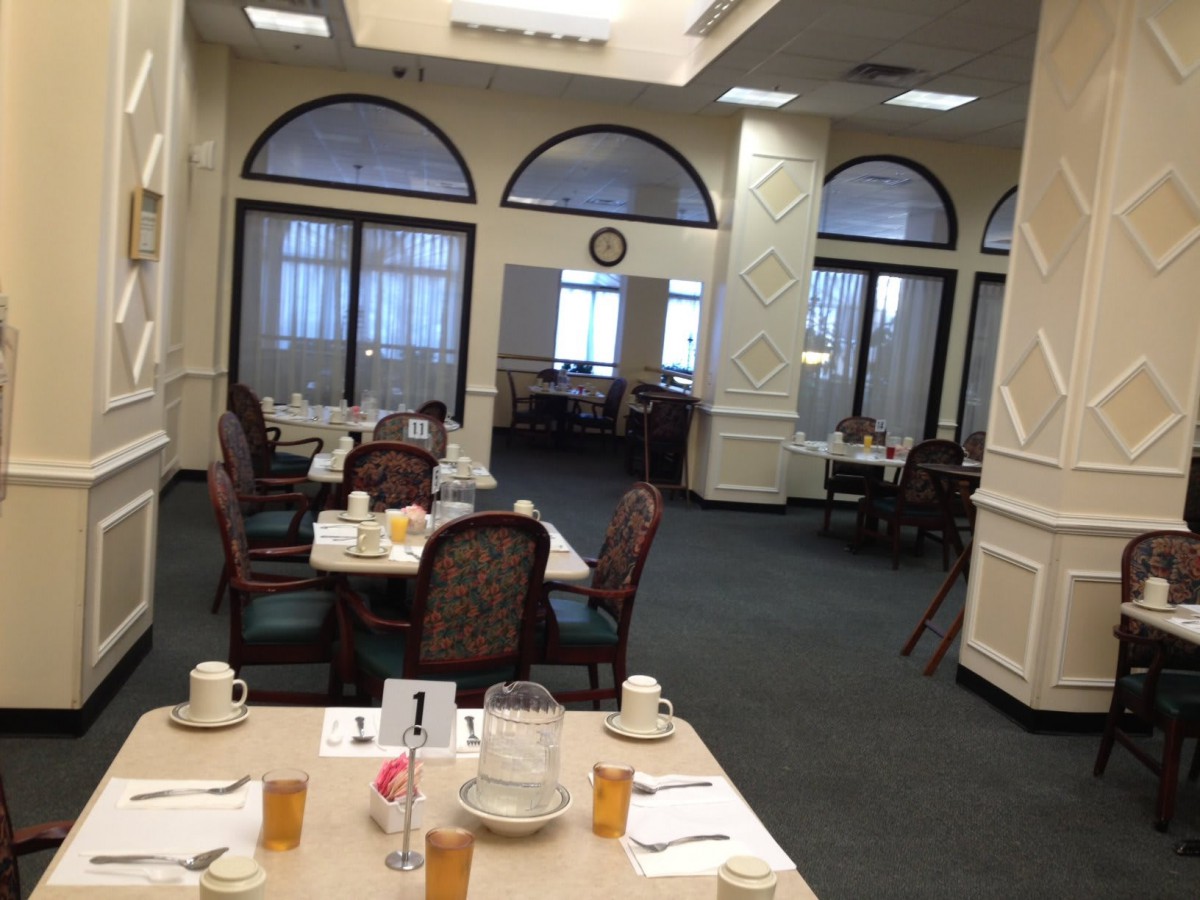 An elegantly set dining area with multiple tables and chairs, ready for guests.