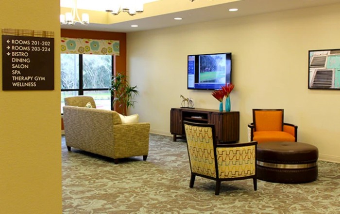 A modern living room with comfortable seating and a mounted television.