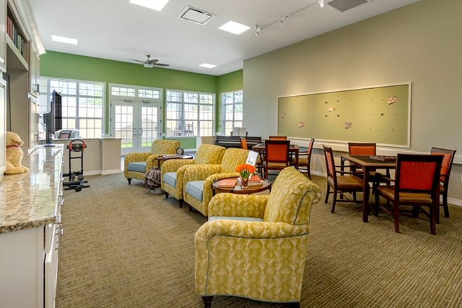 A cozy living area with comfortable seating and bright windows.