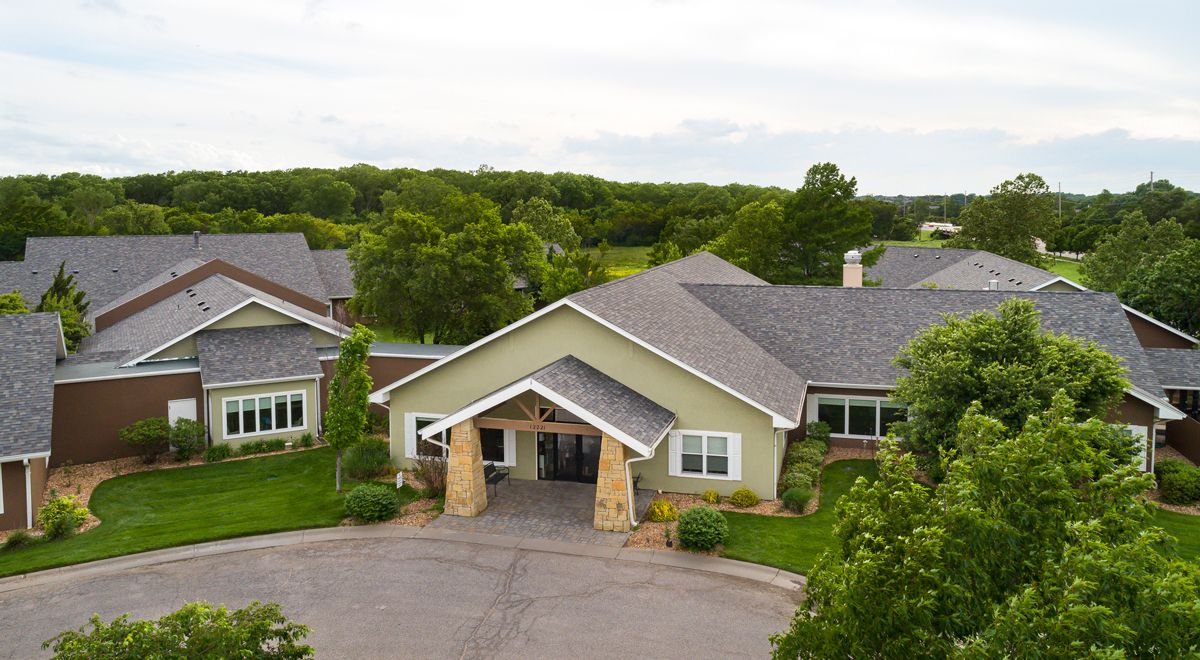 A residential building surrounded by lush greenery.