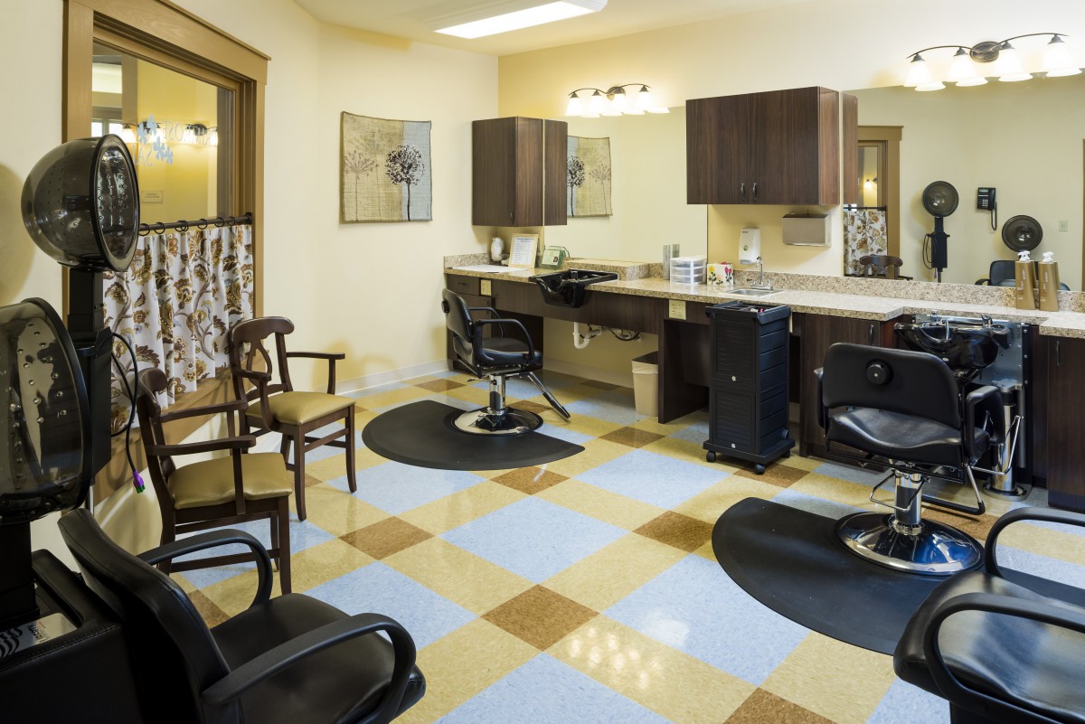 A modern and stylish hair salon interior with chairs and mirrors.