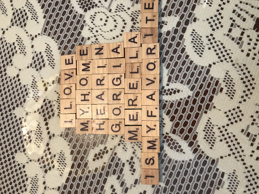 A creative arrangement of Scrabble tiles expressing love for home and favorite places.