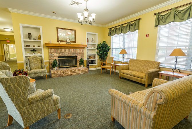 A cozy living room with a fireplace and comfortable seating.