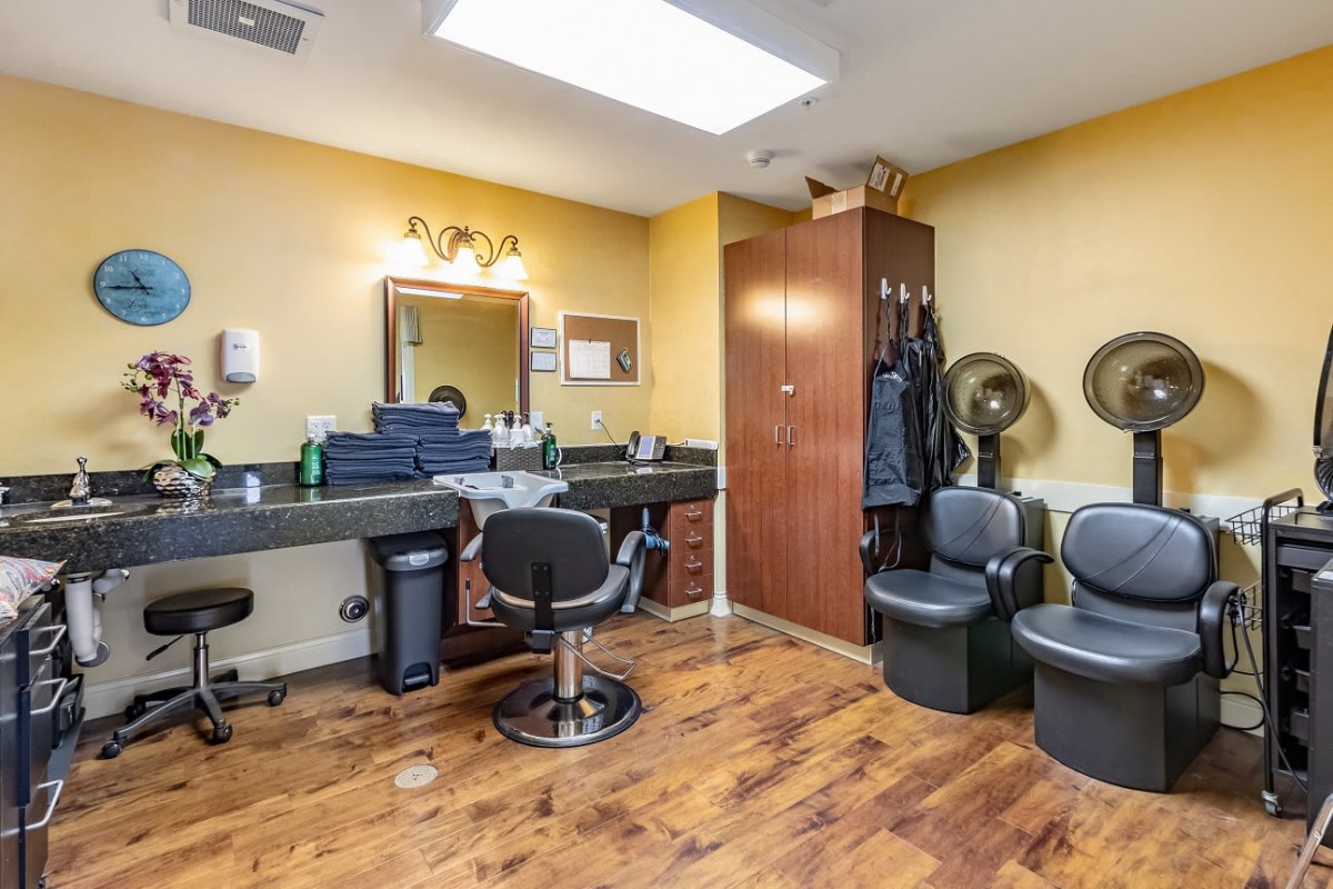 Interior of a hair salon with styling stations and chairs.
