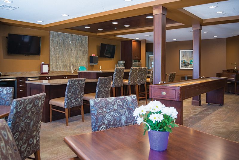 A cozy lounge area with comfortable seating and a bar.