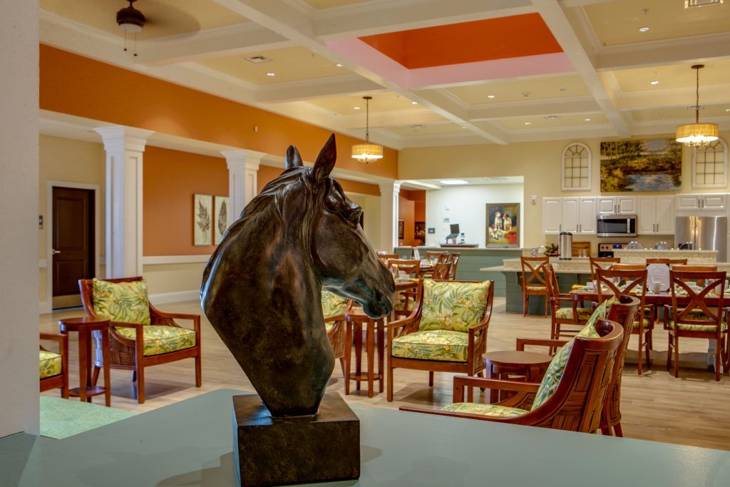 A horse head sculpture prominently displayed in a stylish lounge area.