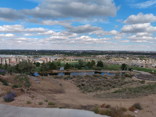 A panoramic view of the landscape showcasing rolling hills and a blue sky dotted with clouds.