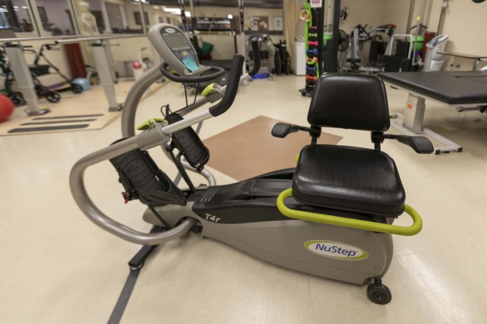 A recumbent exercise bike in a gym setting.