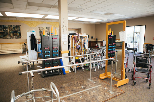 A well-equipped physical therapy room featuring various exercise aids and rehabilitation equipment.