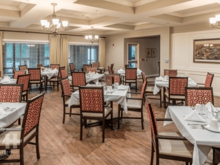 An empty dining room with neatly arranged tables and chairs.