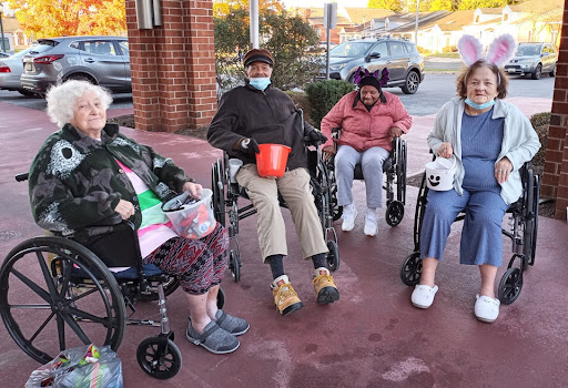 Residents enjoying some time outdoors together at a care facility.