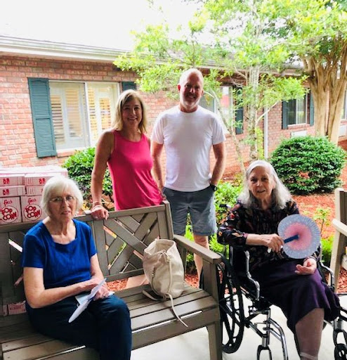 A heartwarming moment shared among family members on a sunny porch.