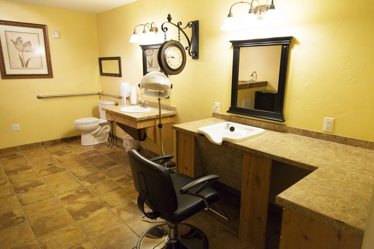 A well-appointed salon area featuring a vanity, mirror, and styling chair.