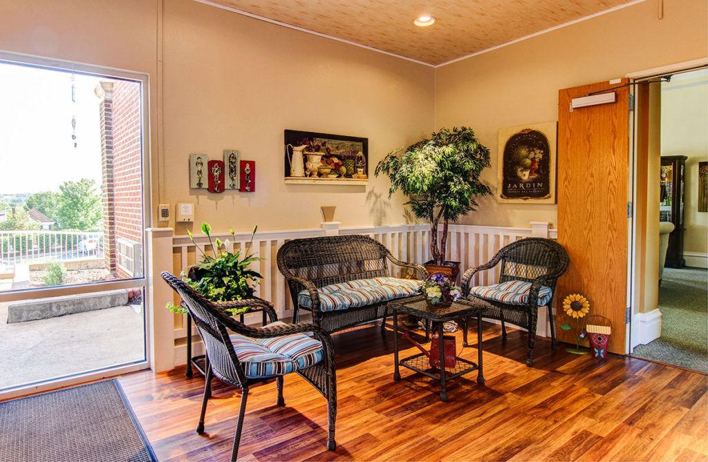 A cozy living room with comfortable seating, decorative plants, and warm lighting.