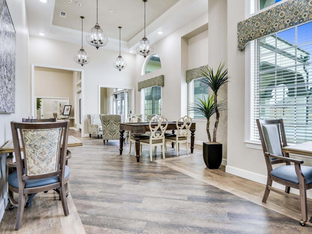 A beautifully decorated dining room with modern furniture and elegant lighting.