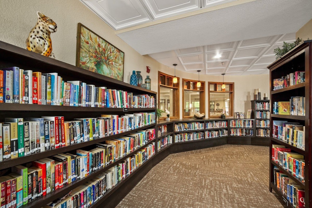 A cozy library with rows of bookshelves and a well-lit interior.