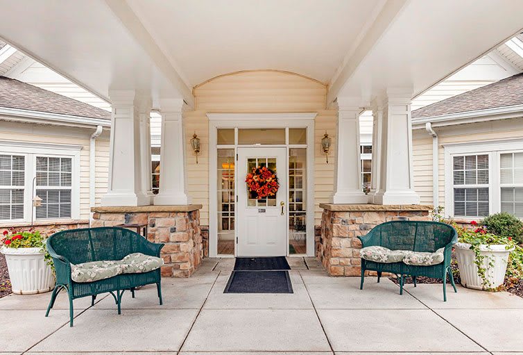 Inviting front porch with decorative wreath and seating area.