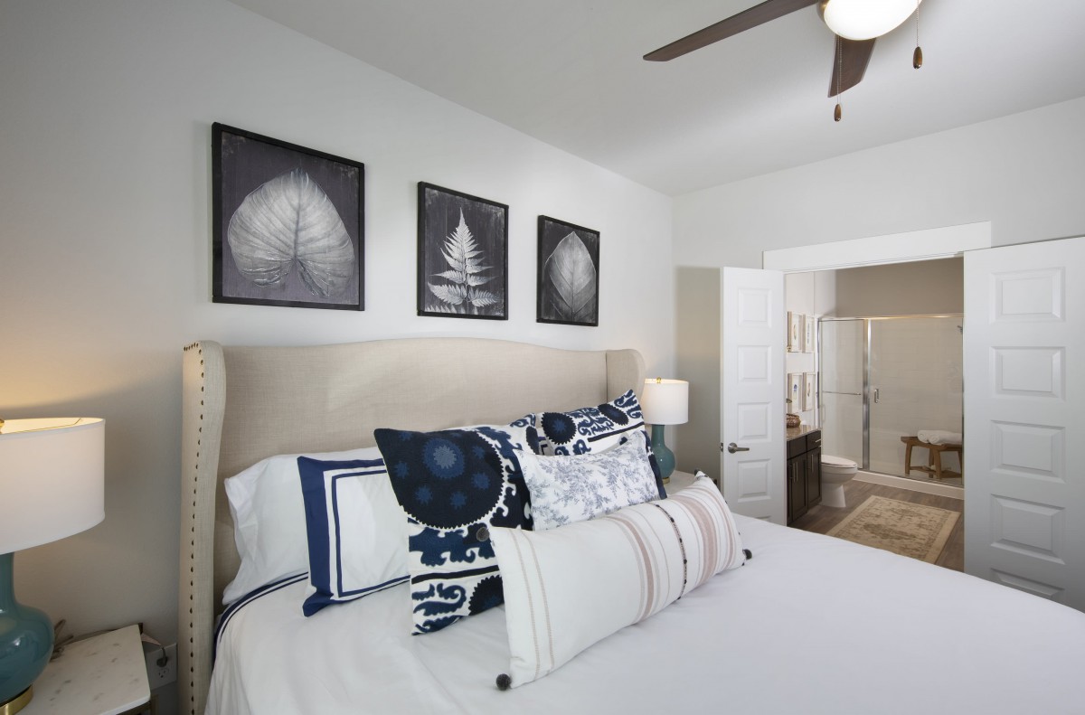 A modern bedroom with stylish decor and comfortable bedding.