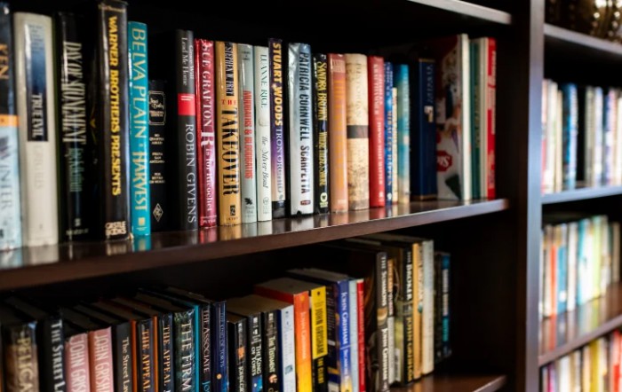 A bookshelf filled with a variety of books.
