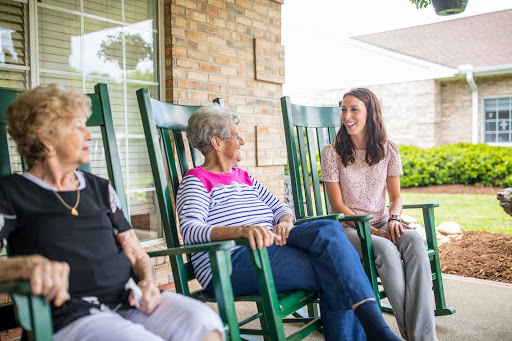 A heartwarming moment shared among family members enjoying a conversation on a porch.